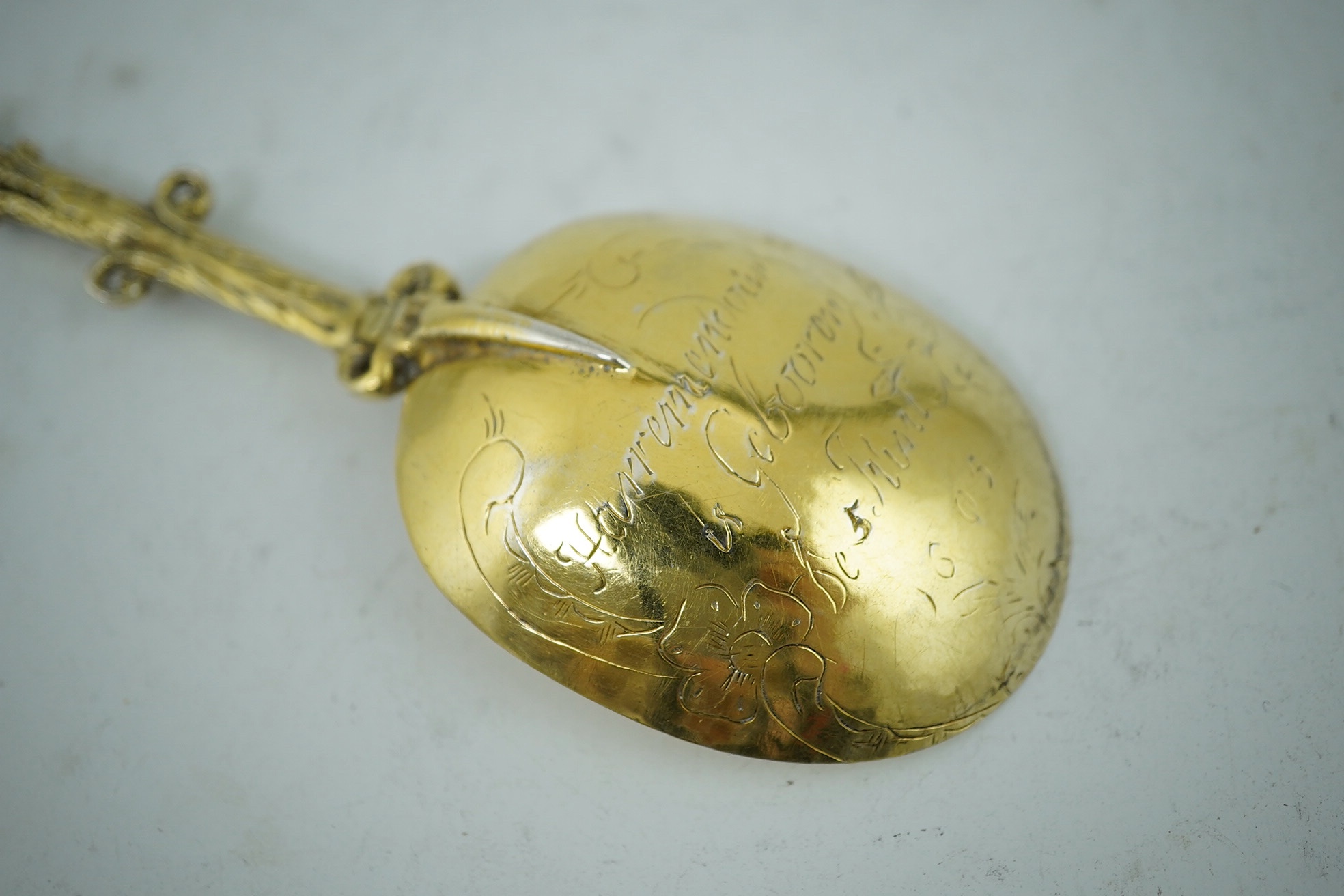 An early 17th century Dutch silver gilt spoon, the terminal modelled as a cow being milked, 17.5cm long, 47g. Condition - fair